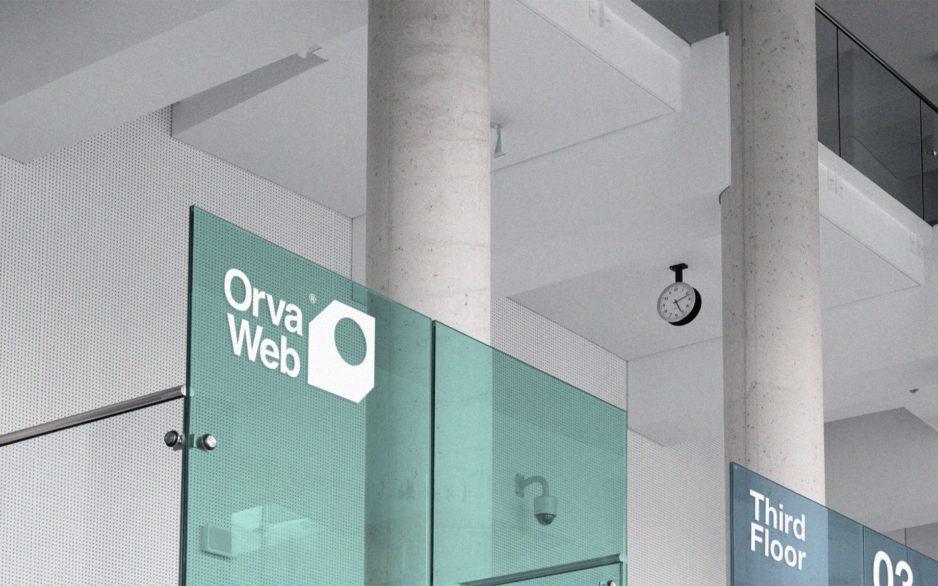 The OrvaWeb logo displayed in a modern office